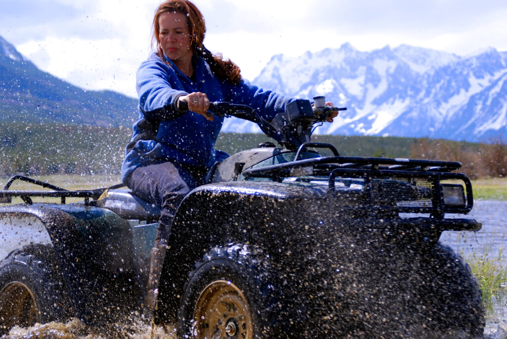 woman on an ATV with mountain in the background